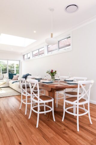 Completed home extension in Epping, Dining room with timber and white furniture